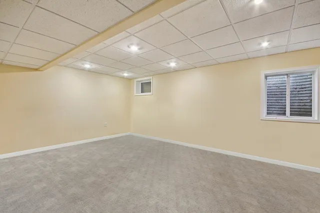 a aerial view of a house with roof deck front of house