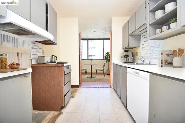 a kitchen with stainless steel appliances a sink stove and cabinets