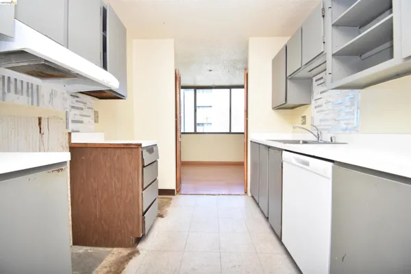 a kitchen with a sink a refrigerator and a stove