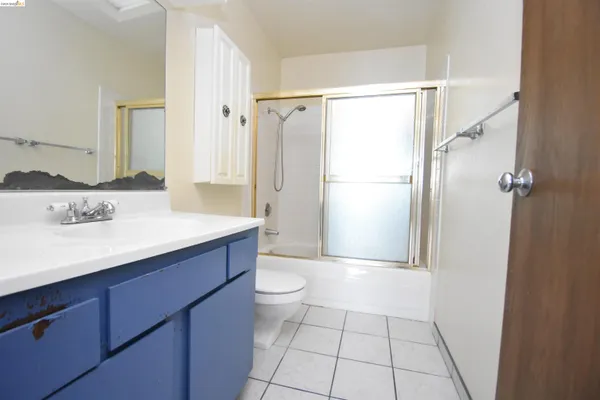 a bathroom with a sink a toilet a mirror and shower