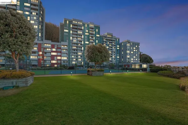 a large building with trees in front of it
