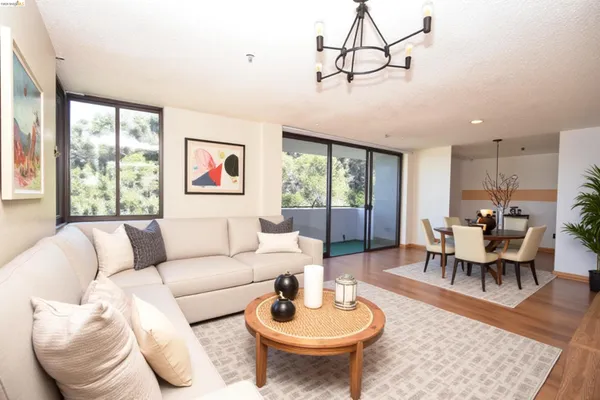 a living room with furniture a rug and a large window