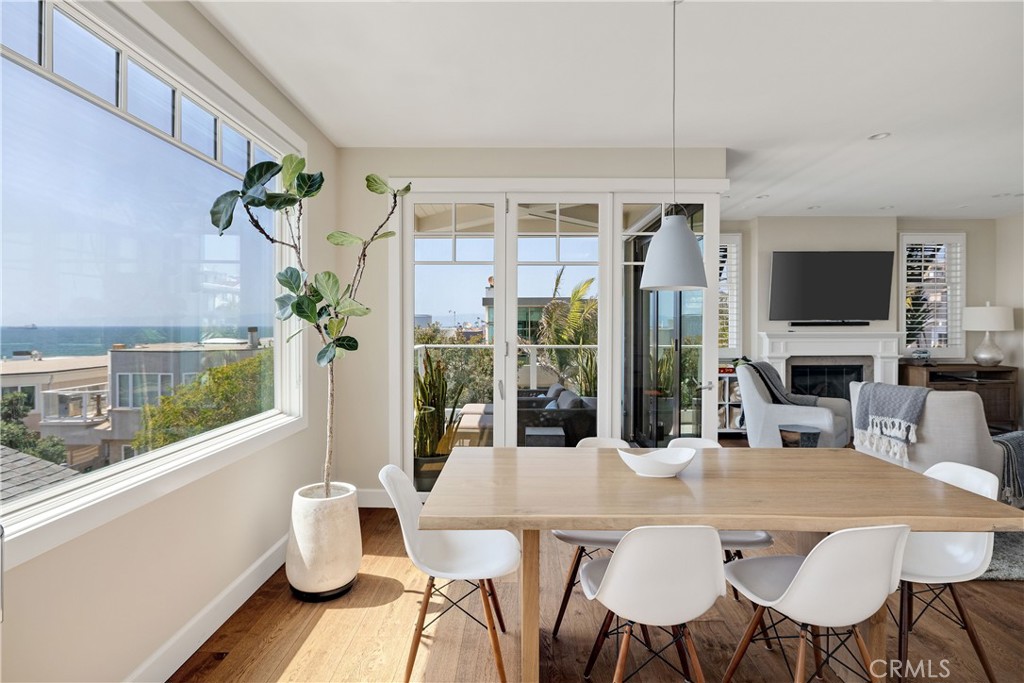 124 23rd Street Manhattan Beach, CA 90266 - Photo 27 of 50 a view of a dining room with furniture a chandelier and wooden floor
