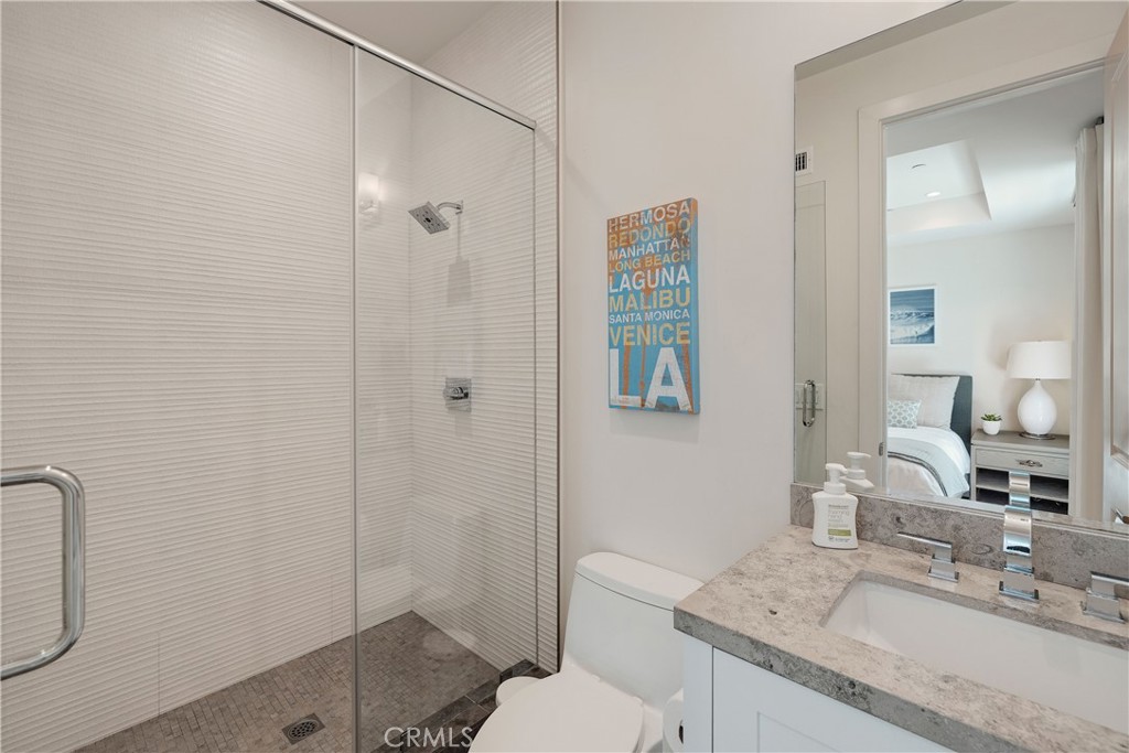 124 23rd Street Manhattan Beach, CA 90266 - Photo 48 of 50 a bathroom with a granite countertop sink a mirror and a shower