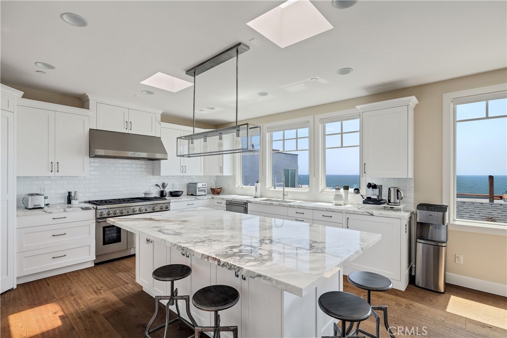 124 23rd Street Manhattan Beach, CA 90266 - Photo 5 of 50 a kitchen with a stove a sink and a refrigerator