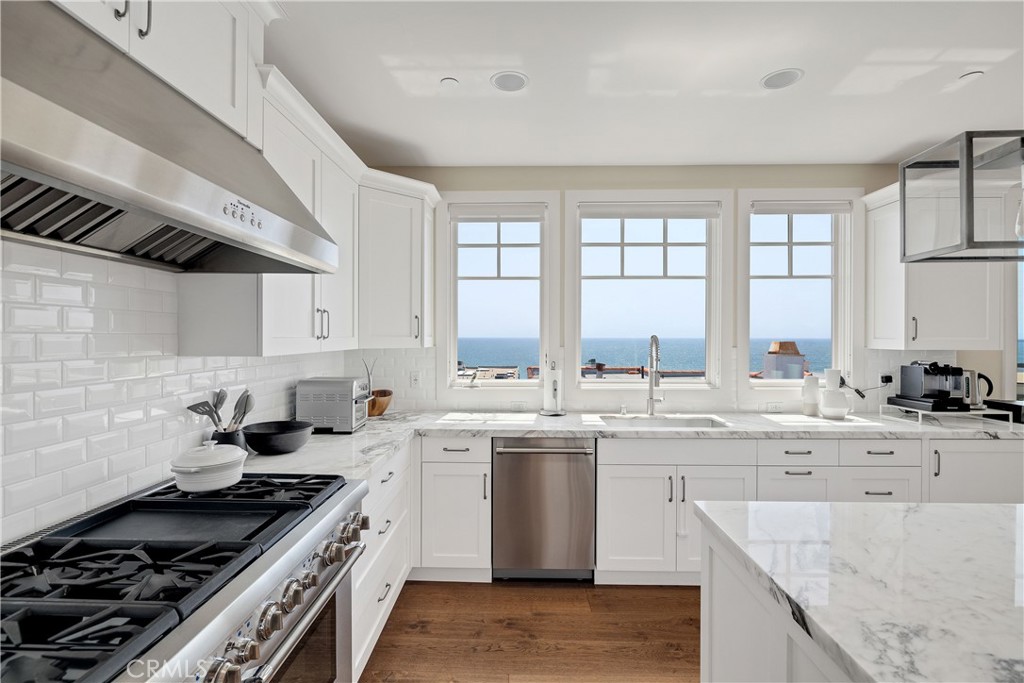 124 23rd Street Manhattan Beach, CA 90266 - Photo 7 of 50 a kitchen with a stove sink and cabinets
