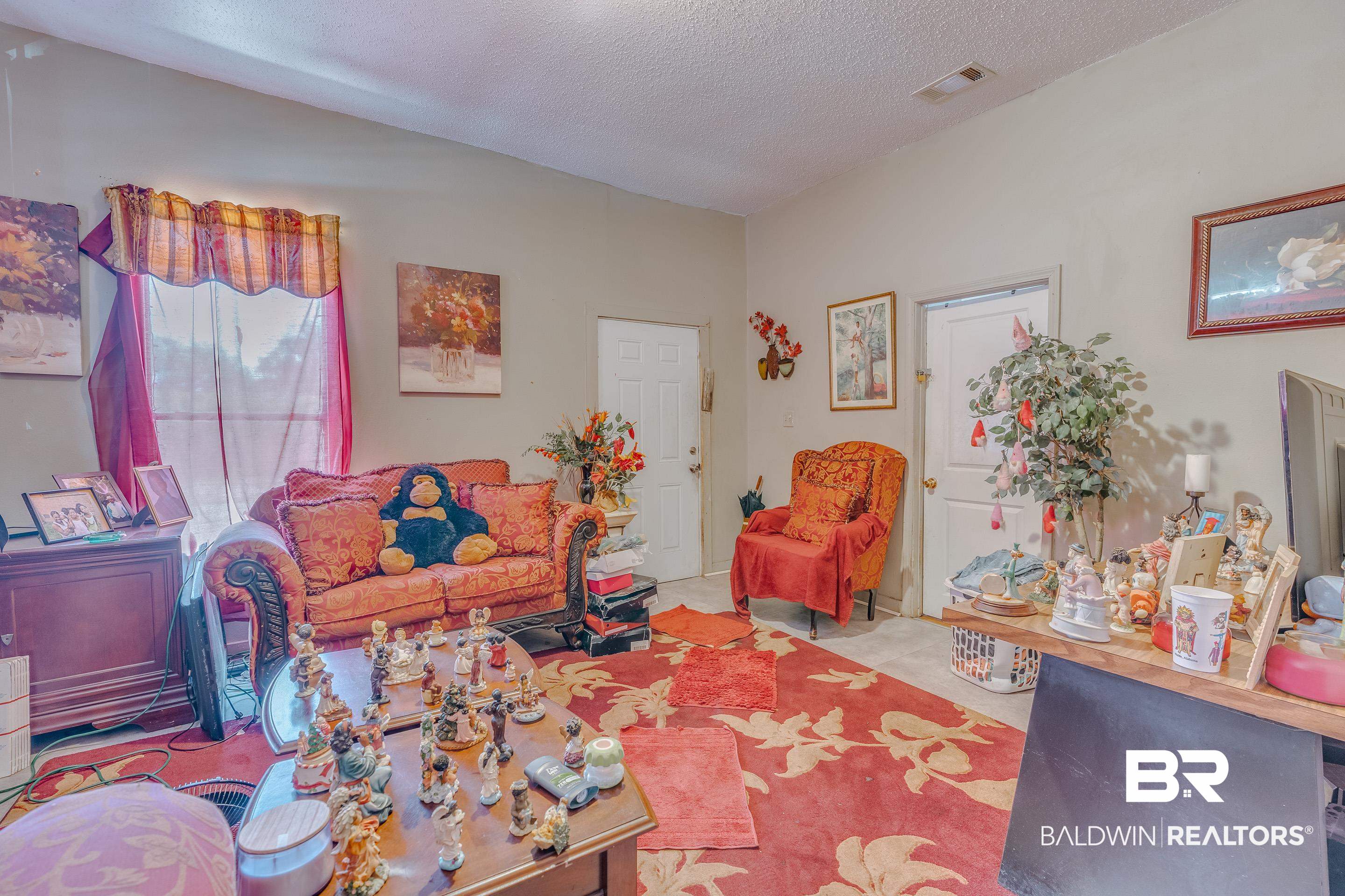 1156 Freeman Street Mobile, AL 36605 - Photo 7 of 22 Living room featuring a textured ceiling and visible vents