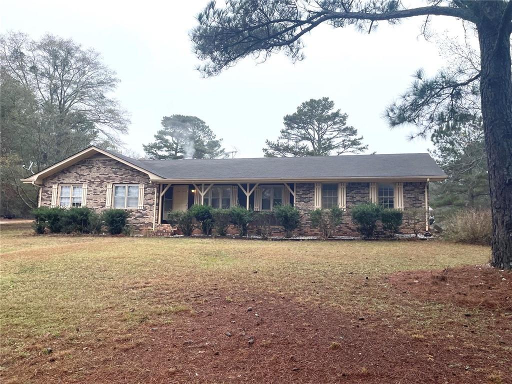12266 Brown Bridge Road Covington, GA 30016 - Photo 2 of 12 a front view of a house with a yard and garage