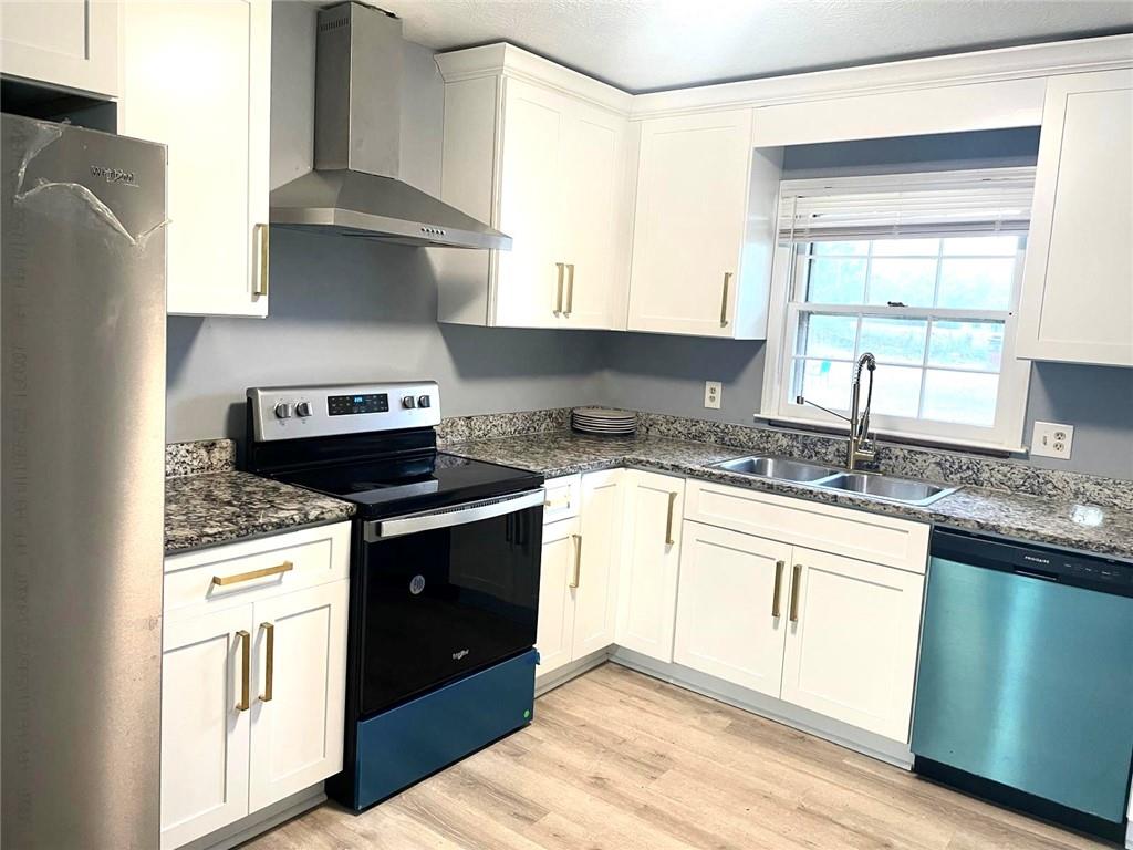 12266 Brown Bridge Road Covington, GA 30016 - Photo 4 of 12 a kitchen with stainless steel appliances granite countertop a stove and a sink