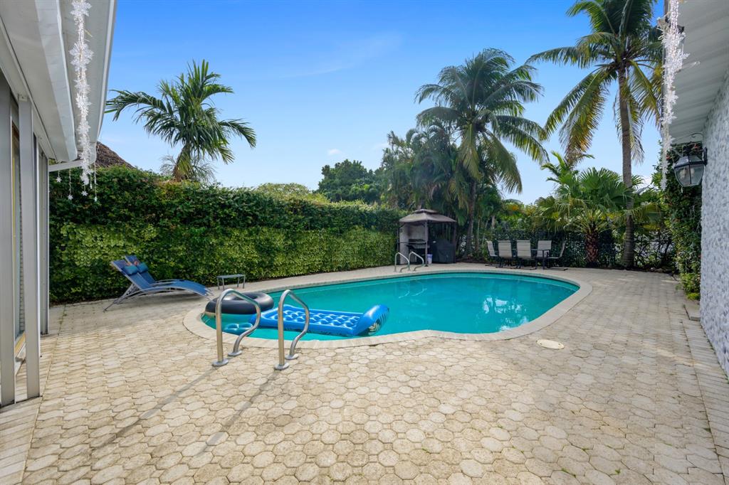 1336 Funston Street Hollywood, FL 33019 - Photo 11 of 51 a view of a swimming pool with a yard