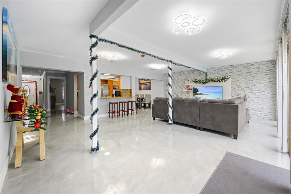 1336 Funston Street Hollywood, FL 33019 - Photo 15 of 51 a living room with furniture and a flat screen tv