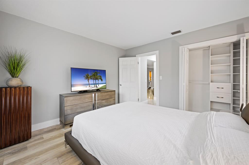 1336 Funston Street Hollywood, FL 33019 - Photo 25 of 51 a bedroom with a bed and a flat screen tv