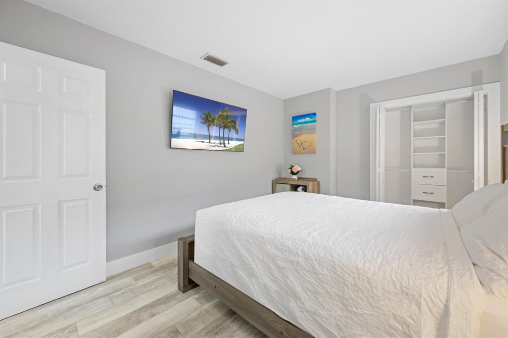 1336 Funston Street Hollywood, FL 33019 - Photo 28 of 51 a bedroom with a bed and a painting on the wall