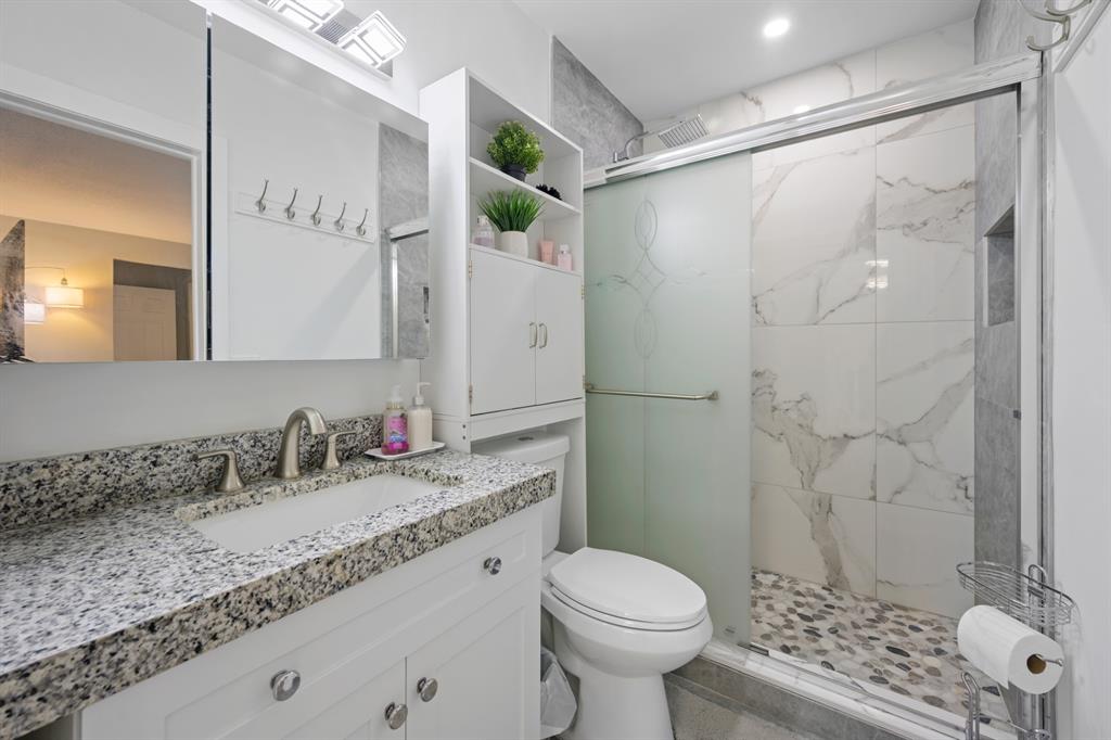 1336 Funston Street Hollywood, FL 33019 - Photo 29 of 51 a bathroom with a granite countertop sink toilet and shower