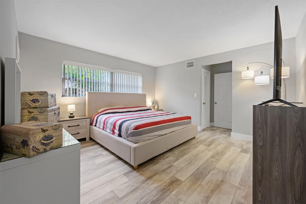 1336 Funston Street Hollywood, FL 33019 - Photo 31 of 51 a bedroom with a bed and wooden floor