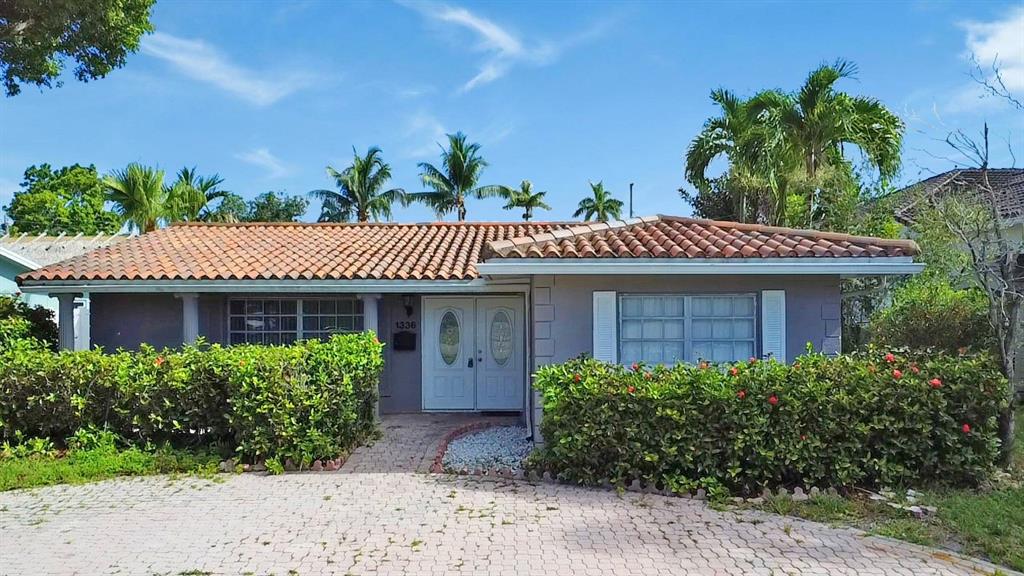 1336 Funston Street Hollywood, FL 33019 - Photo 50 of 51 a front view of a house with plants