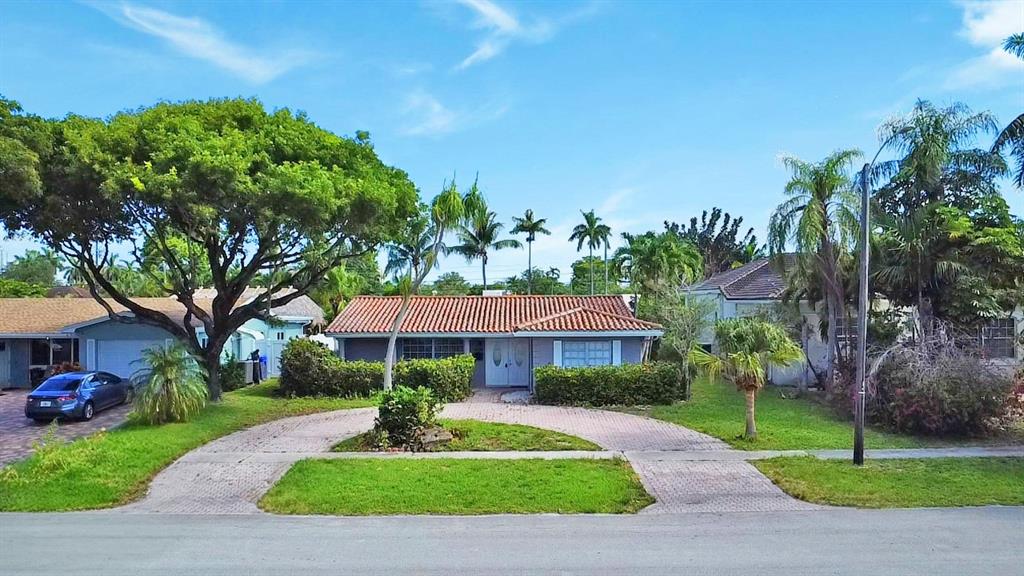 1336 Funston Street Hollywood, FL 33019 - Photo 51 of 51 a front view of a house with a yard