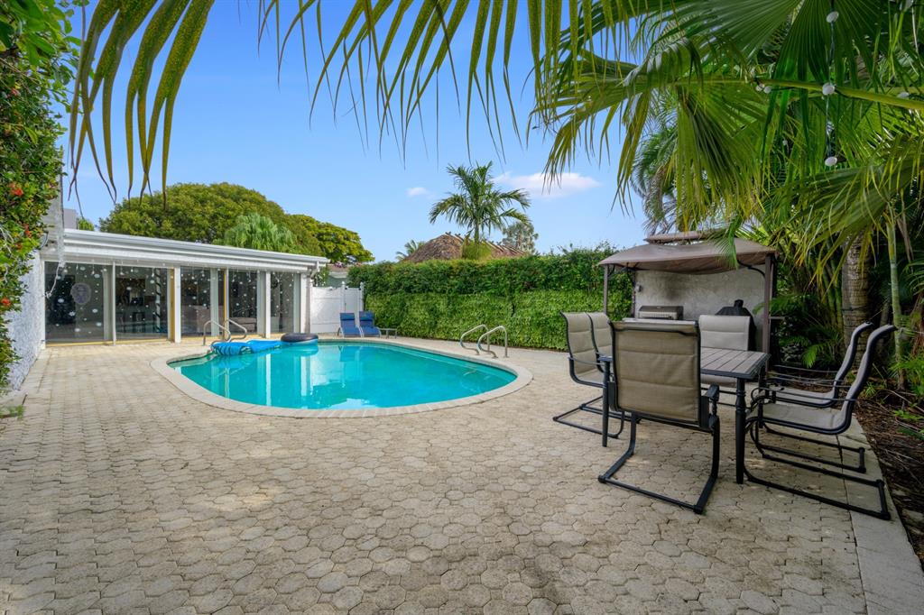 1336 Funston Street Hollywood, FL 33019 - Photo 6 of 51 a view of a house with a swimming pool and sitting area