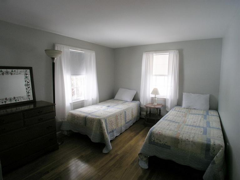 14 Knox Road Dennis Port, MA 02639 - Photo 12 of 14 a bedroom with two beds a lamp and a window