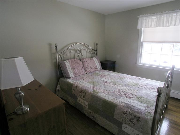 14 Knox Road Dennis Port, MA 02639 - Photo 13 of 14 a bedroom with a bed and a window
