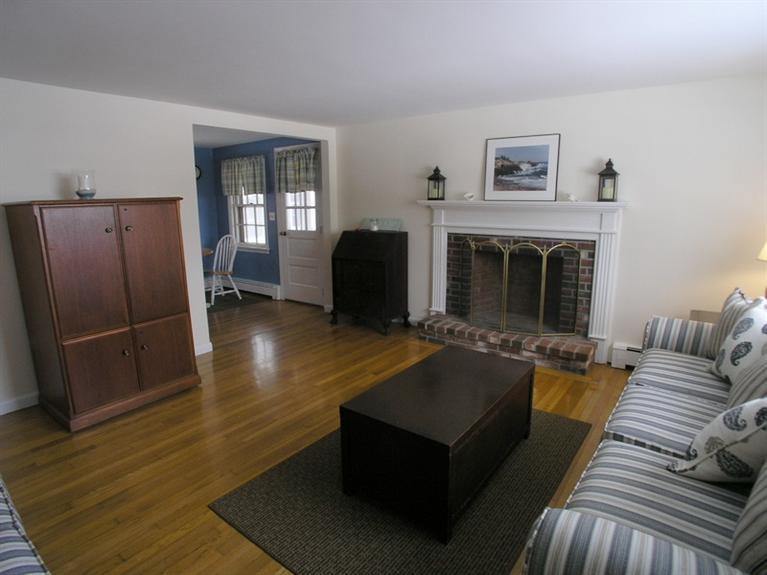 14 Knox Road Dennis Port, MA 02639 - Photo 4 of 14 a living room with furniture rug and a fireplace