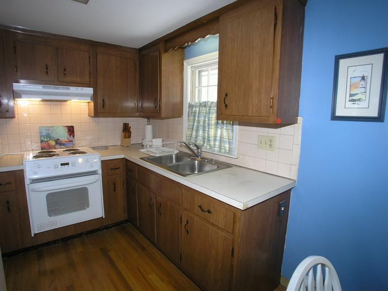 14 Knox Road Dennis Port, MA 02639 - Photo 8 of 14 a kitchen with a sink stove and cabinets
