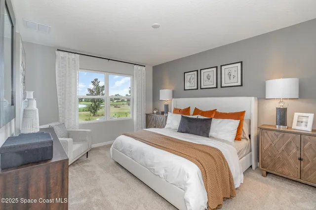 a bedroom with a large bed and a couch