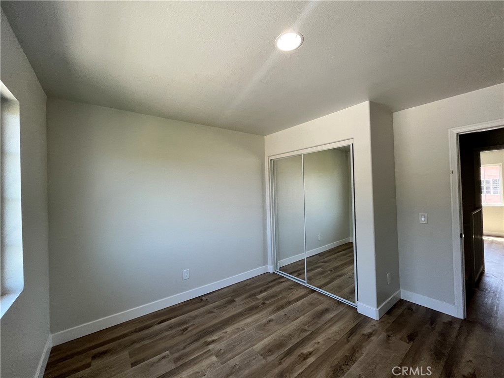 1004 South Riverside Avenue, Unit A3 Rialto, CA 92376 - Photo 4 of 10 an empty room with wooden floor and closet