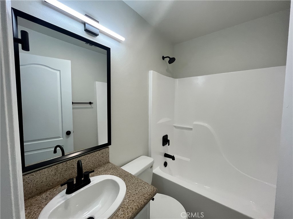 1004 South Riverside Avenue, Unit A3 Rialto, CA 92376 - Photo 7 of 10 a bathroom with a sink toilet and shower