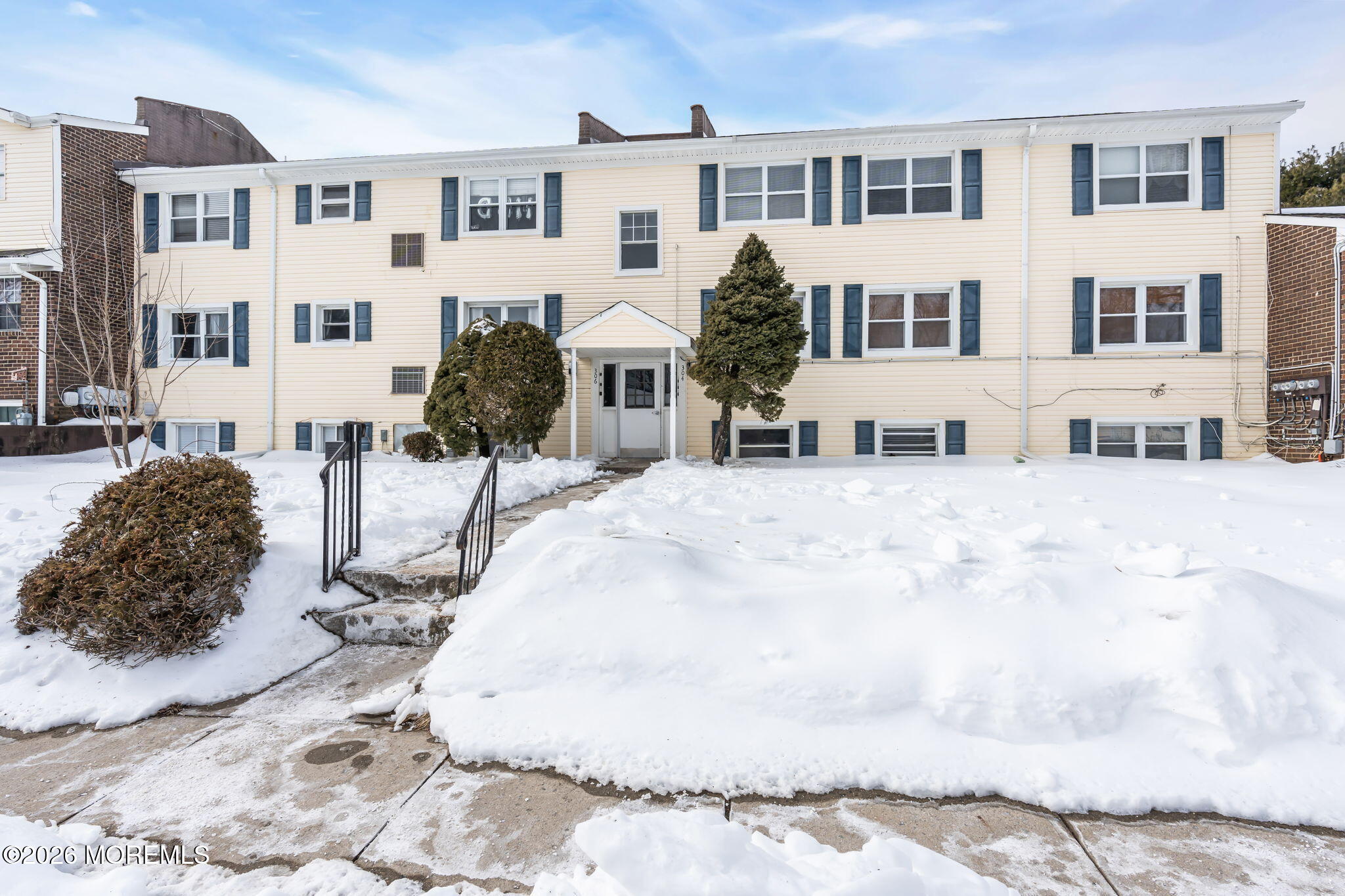 a view of a building with a yard covered in snow