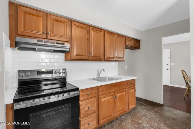 a kitchen with stainless steel appliances granite countertop a stove and a sink