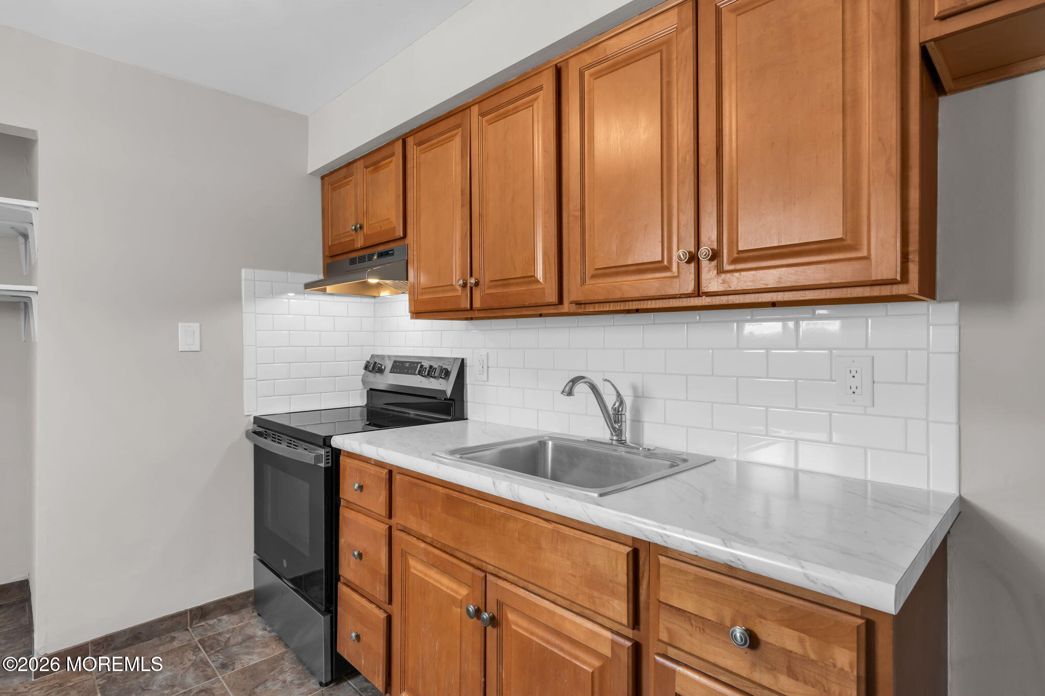 306 Sawmill Road, Unit 182 Brick, NJ 08724 - Photo 18 of 24 a kitchen with stainless steel appliances granite countertop a sink and a white cabinets