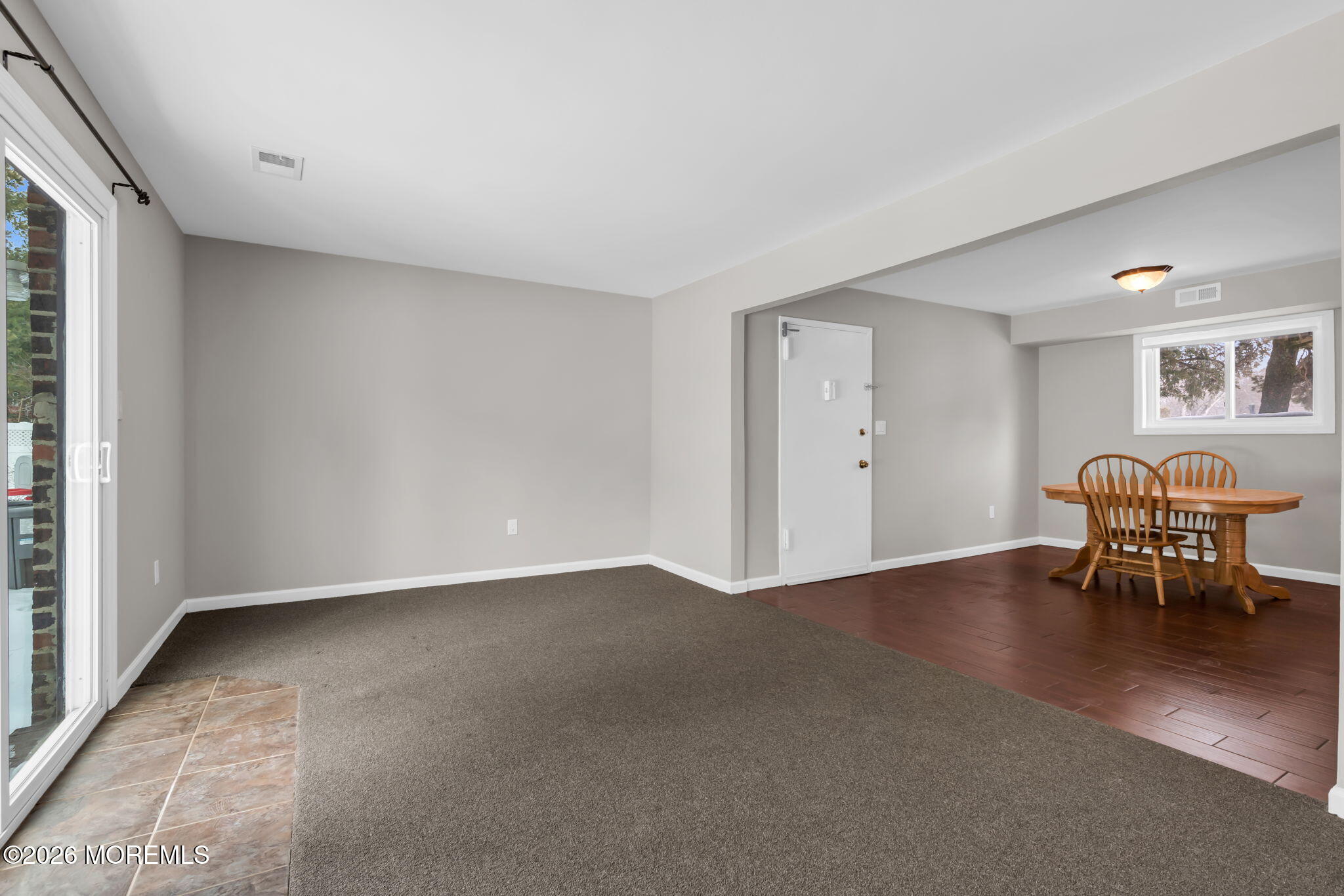 306 Sawmill Road, Unit 182 Brick, NJ 08724 - Photo 9 of 24 an empty room with furniture and wooden floor