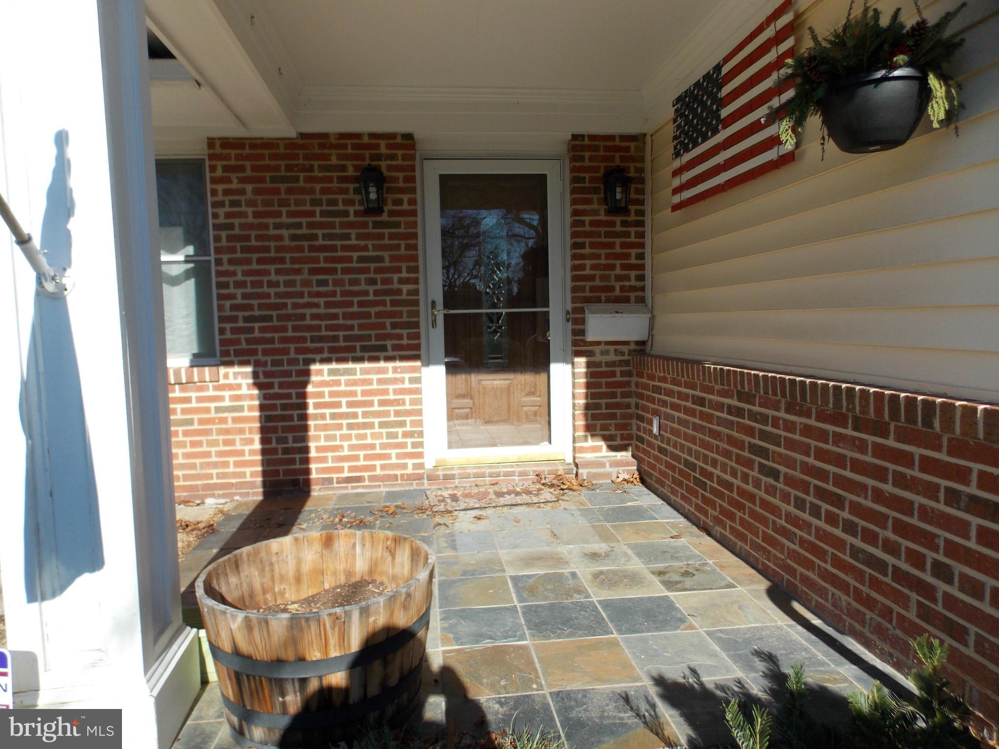 7308 Inzer Street Springfield, VA 22151 - Photo 4 of 30 a view of a balcony with two chairs and a potted plant