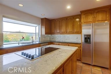 3786 Foxglove Lane Fallbrook, CA 92028 - Photo 15 of 34 a kitchen with a refrigerator a sink and cabinets