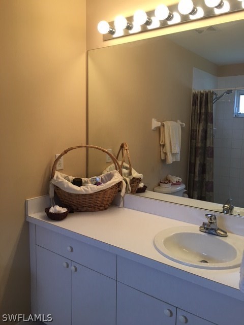 15699 Spring Line Lane Fort Myers, FL 33905 - Photo 8 of 12 a bathroom with a sink and a mirror