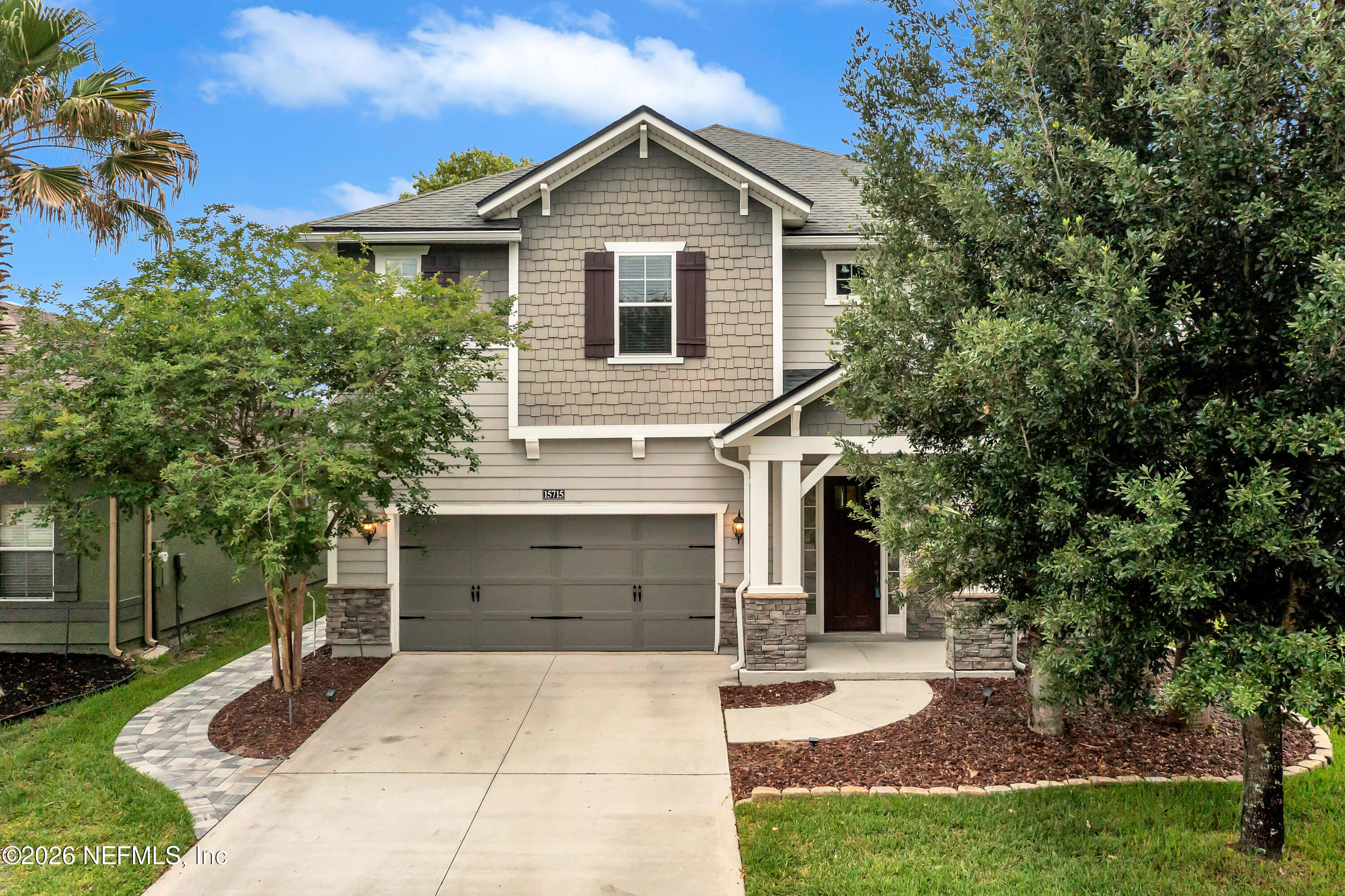 a front view of a house with a yard and garage