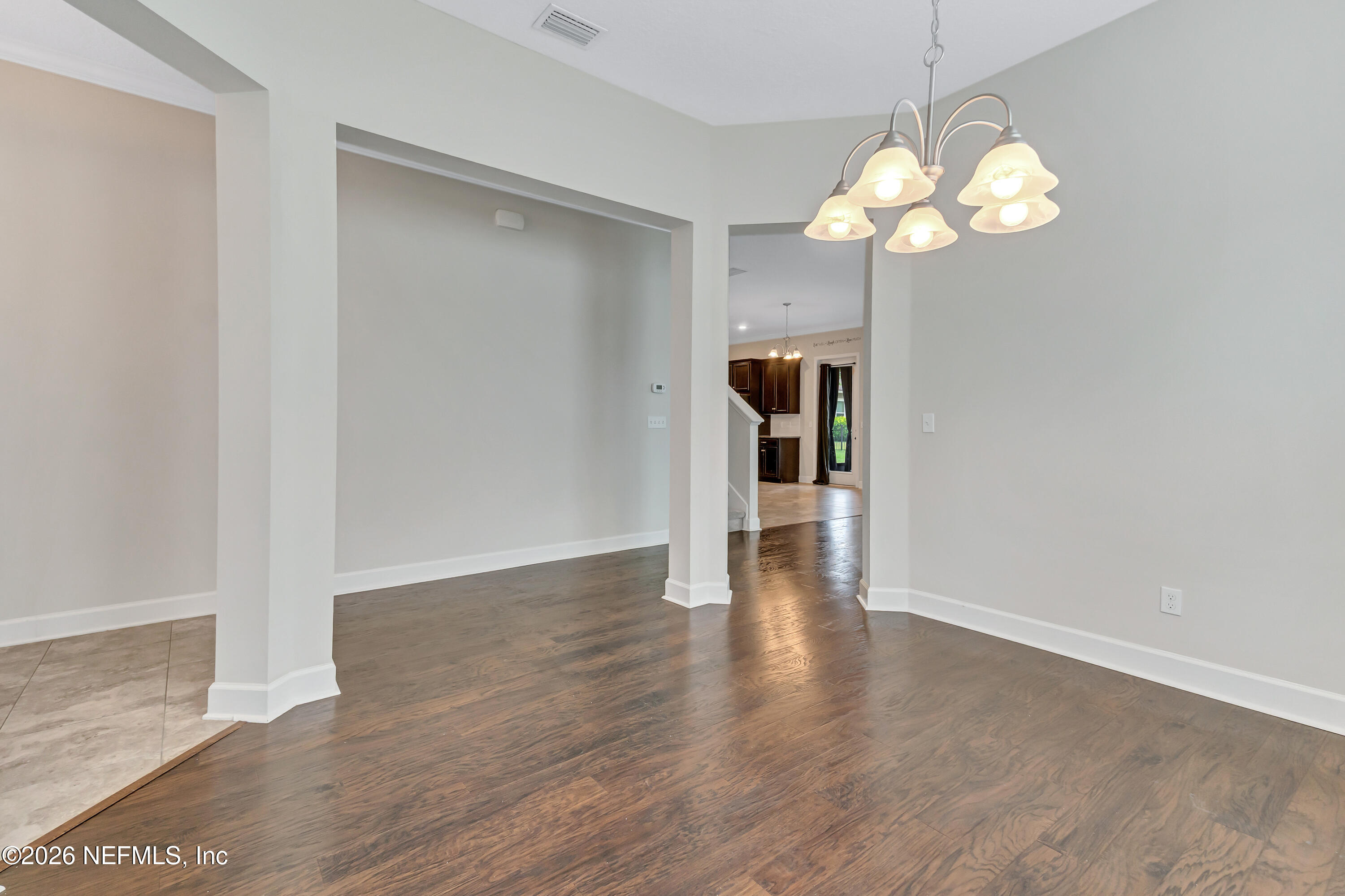 15715 Tisons Bluff Road Jacksonville, FL 32218 - Photo 11 of 48 a view of an empty room with wooden floor
