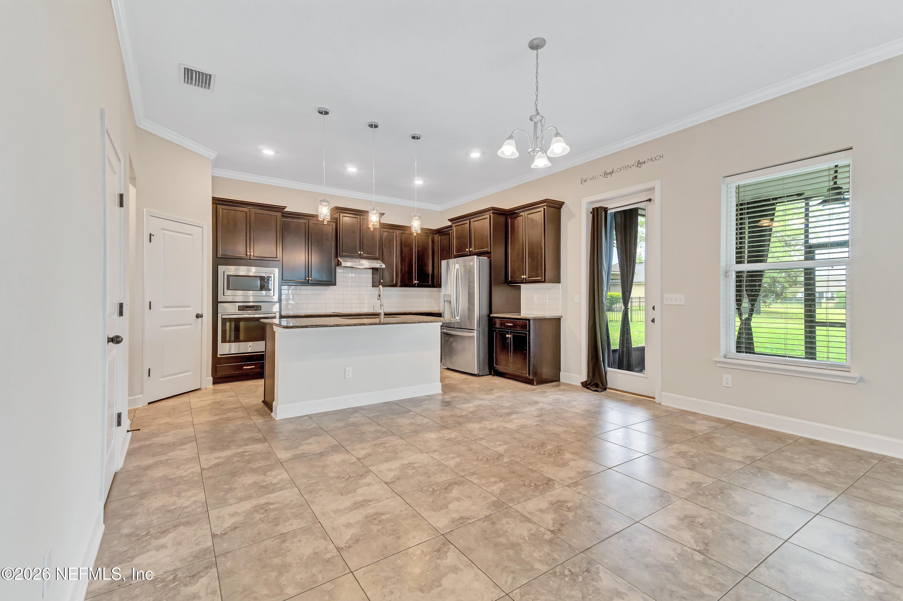 15715 Tisons Bluff Road Jacksonville, FL 32218 - Photo 12 of 48 a view of kitchen with stainless steel appliances refrigerator oven microwave and cabinets