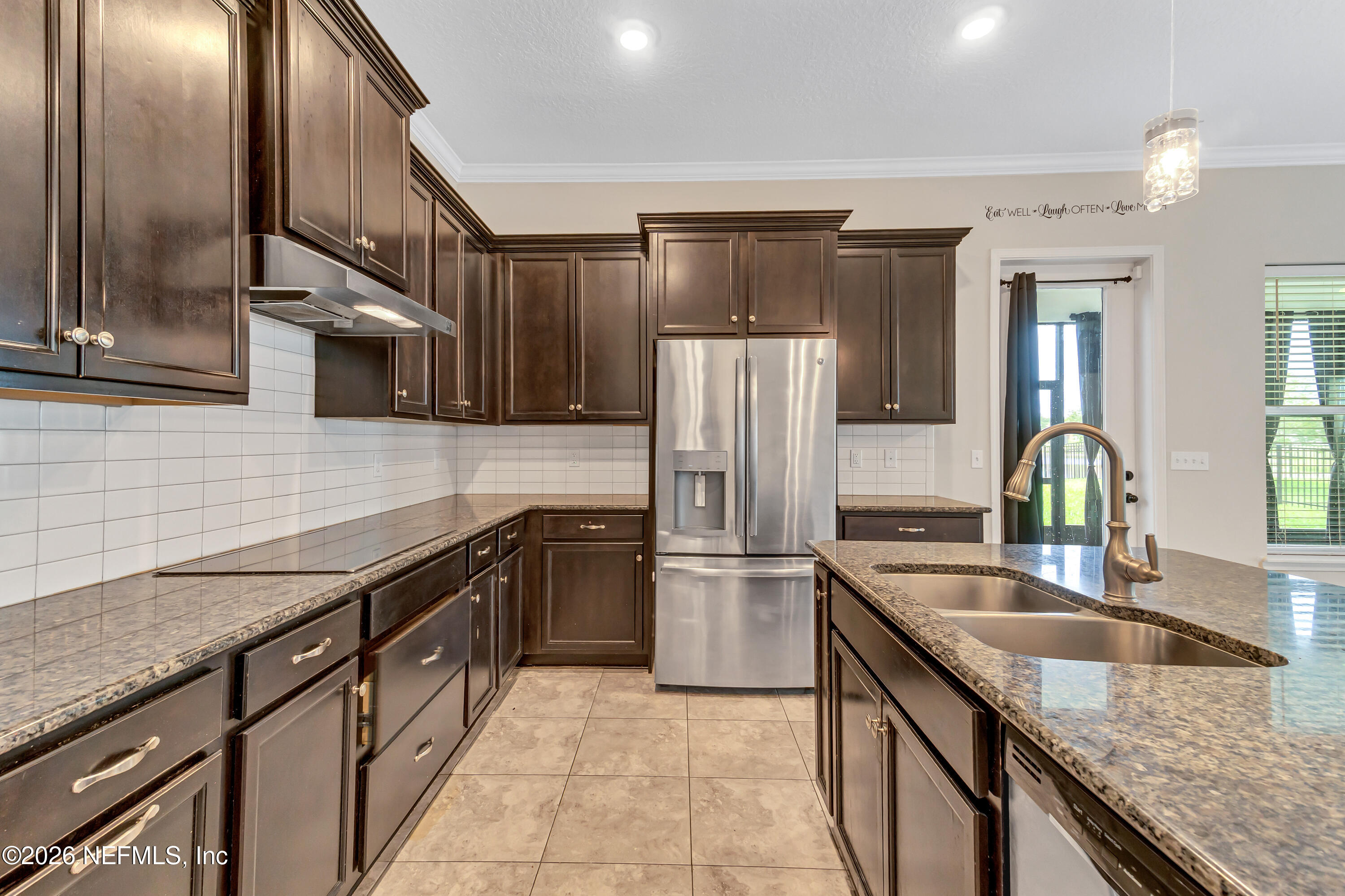 15715 Tisons Bluff Road Jacksonville, FL 32218 - Photo 15 of 48 a kitchen with stainless steel appliances granite countertop a sink stove and refrigerator