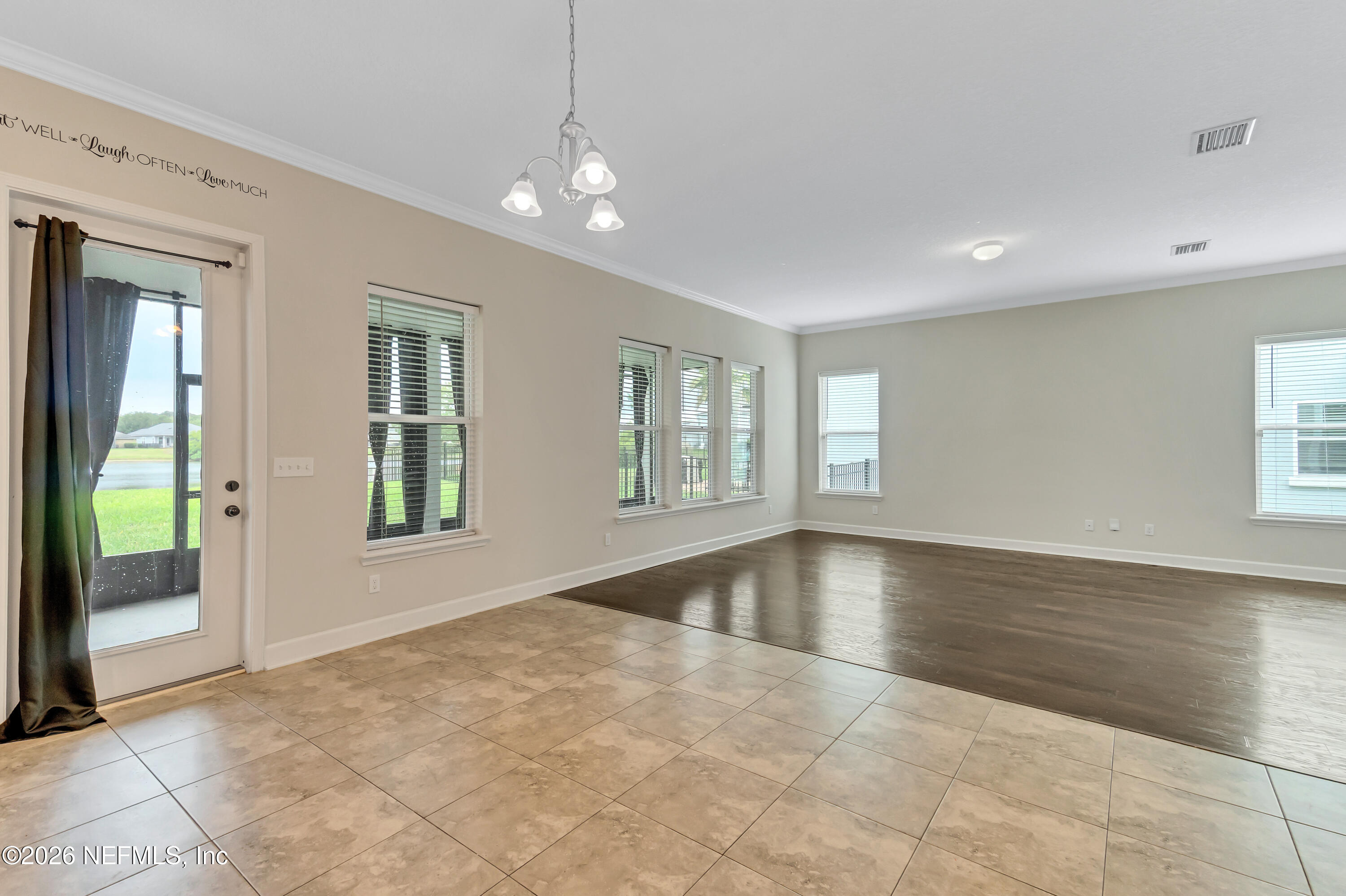 15715 Tisons Bluff Road Jacksonville, FL 32218 - Photo 16 of 48 a view of an empty room with window and wooden floor