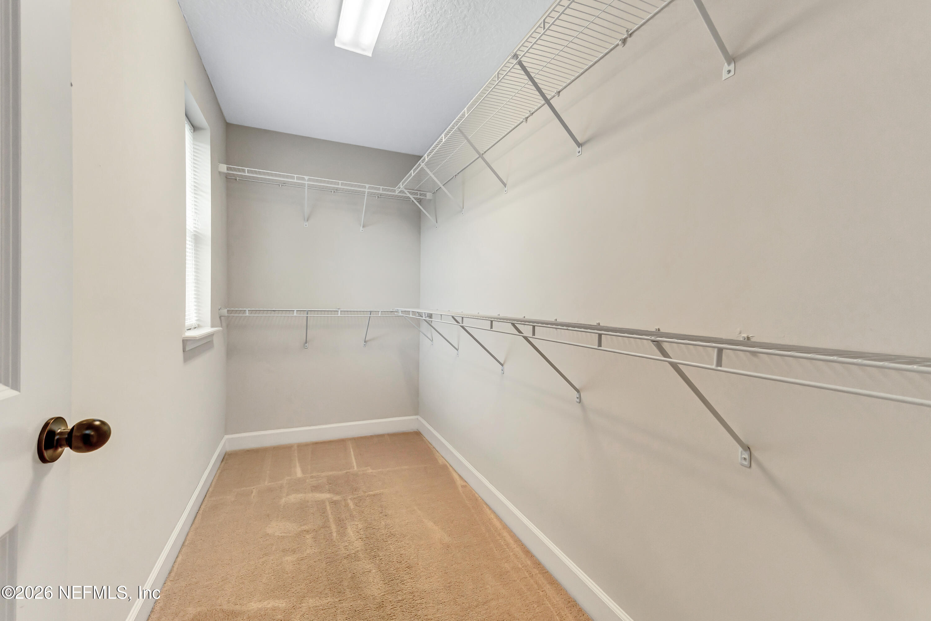 15715 Tisons Bluff Road Jacksonville, FL 32218 - Photo 24 of 48 a view of a room with racks on the wall