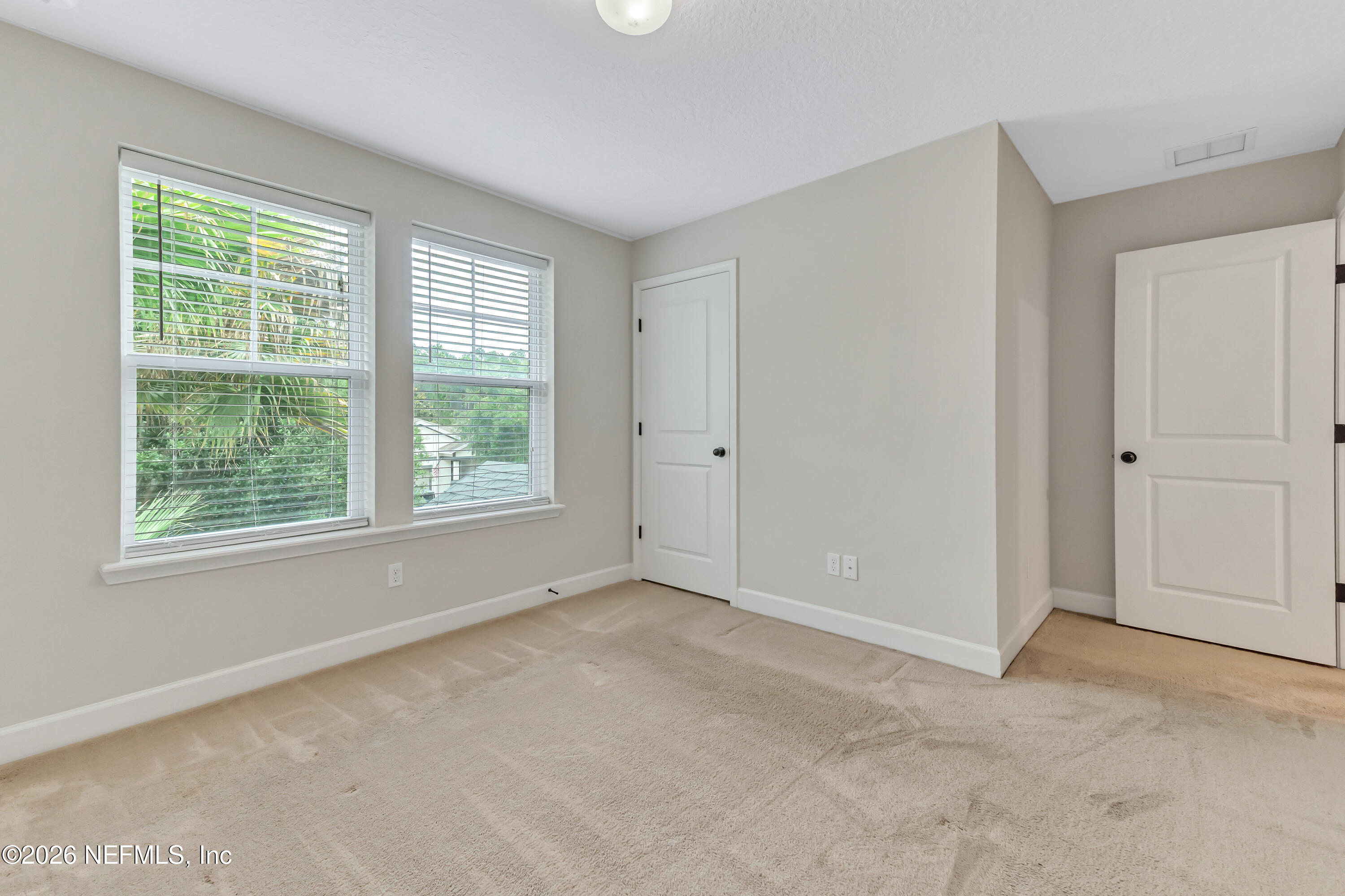 15715 Tisons Bluff Road Jacksonville, FL 32218 - Photo 28 of 48 an empty room with windows and closet