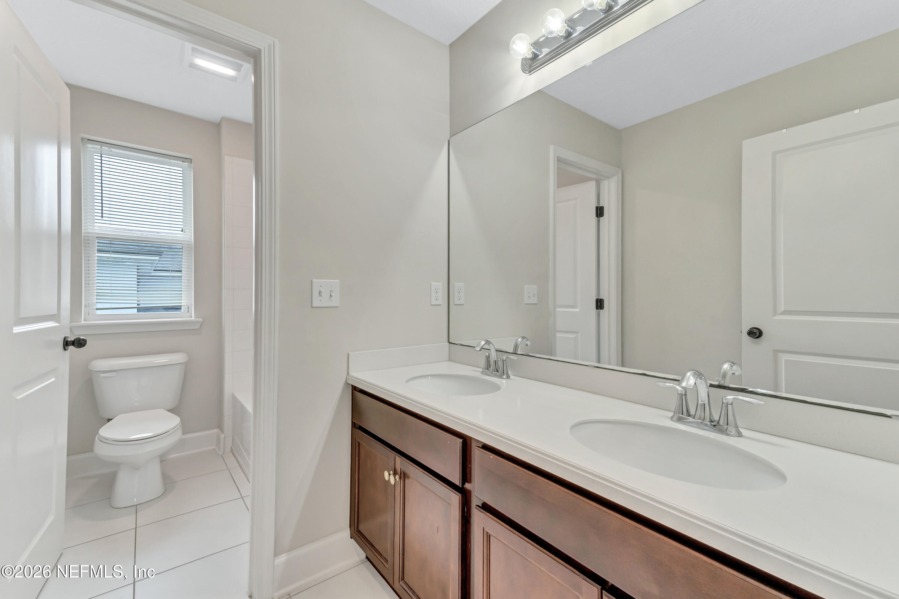 15715 Tisons Bluff Road Jacksonville, FL 32218 - Photo 29 of 48 a bathroom with a granite countertop sink a toilet and a mirror