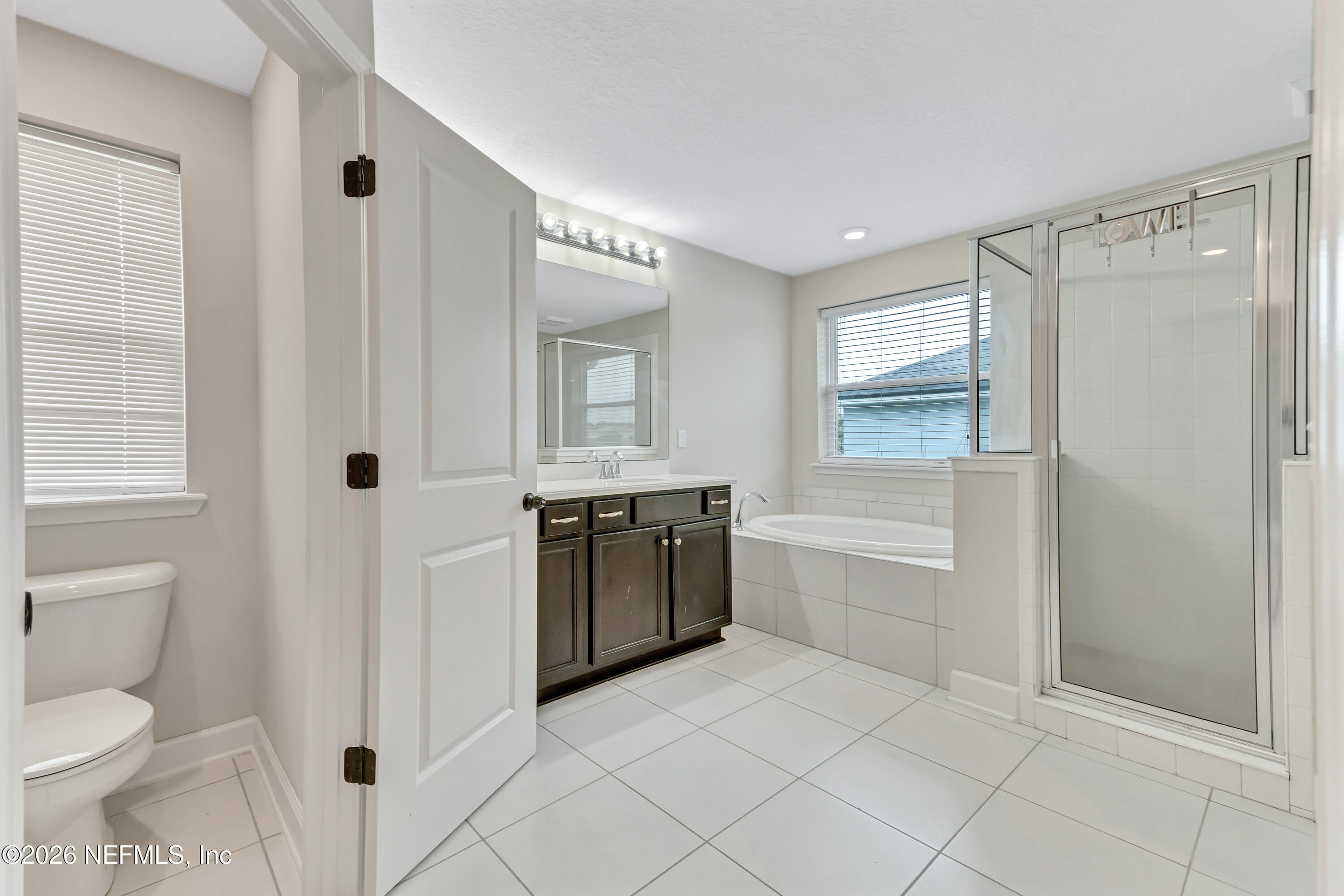 15715 Tisons Bluff Road Jacksonville, FL 32218 - Photo 41 of 48 a spacious bathroom with a granite countertop sink a toilet and shower