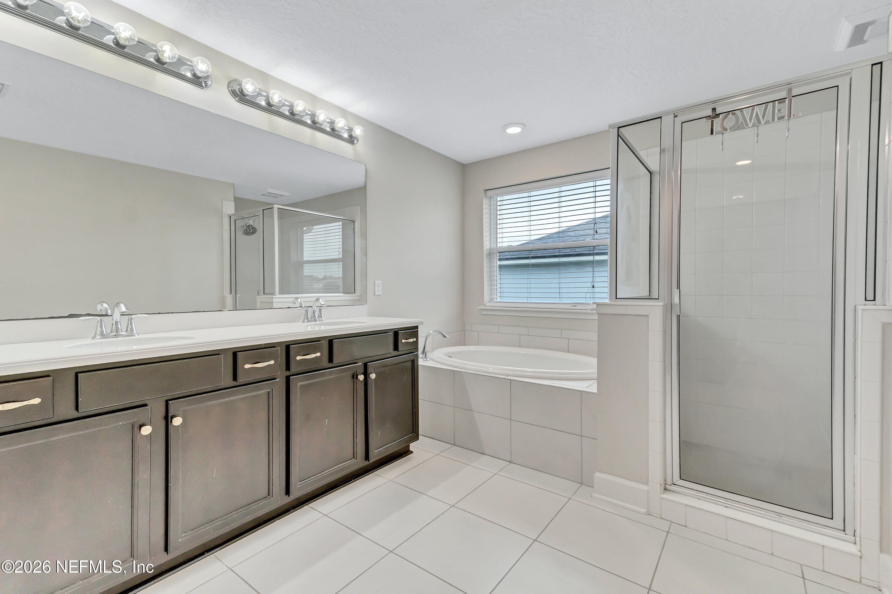 15715 Tisons Bluff Road Jacksonville, FL 32218 - Photo 42 of 48 a spacious bathroom with a double vanity sink a mirror and a bathtub