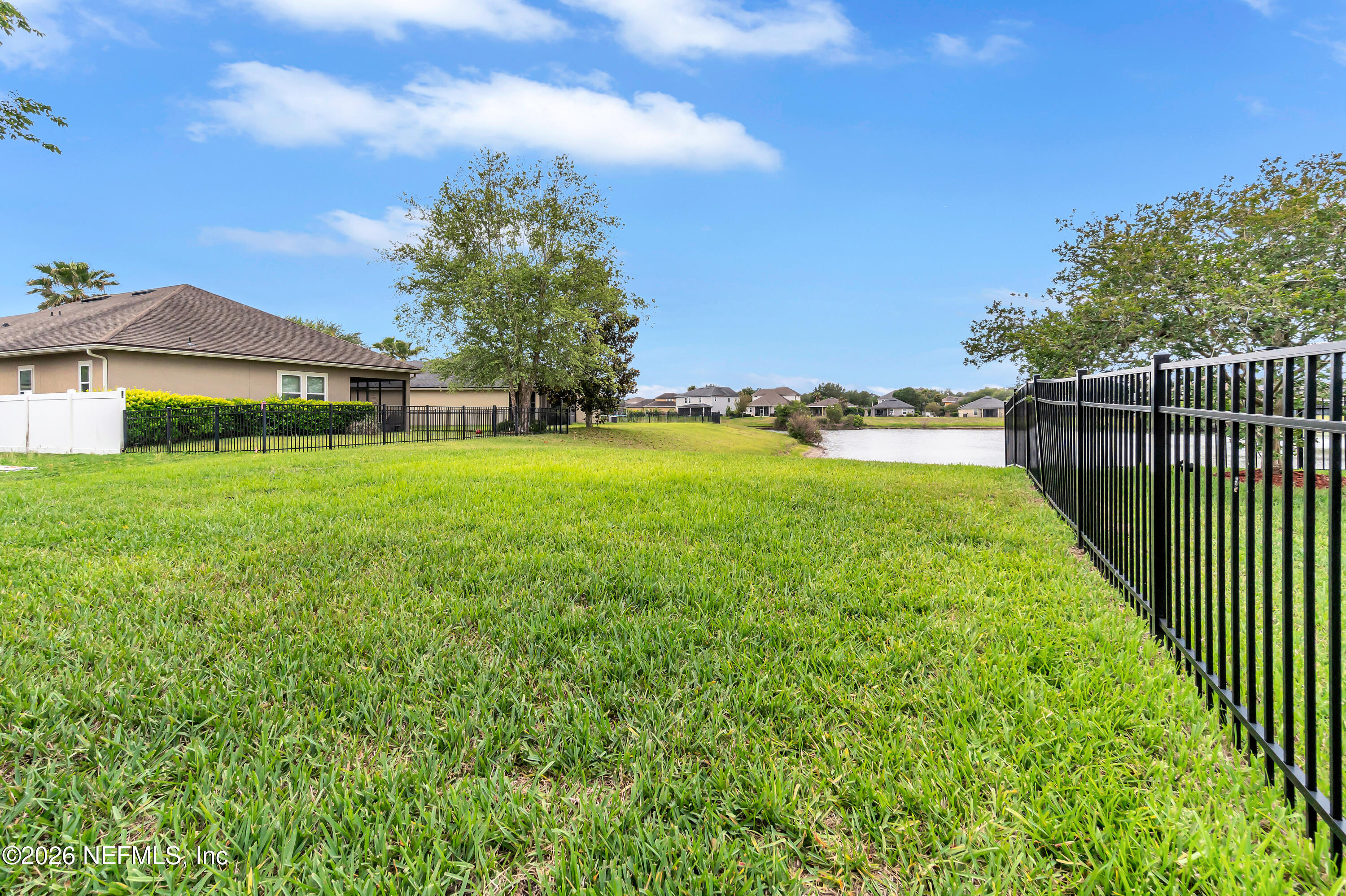 15715 Tisons Bluff Road Jacksonville, FL 32218 - Photo 6 of 48 a view of a garden with a building in the background