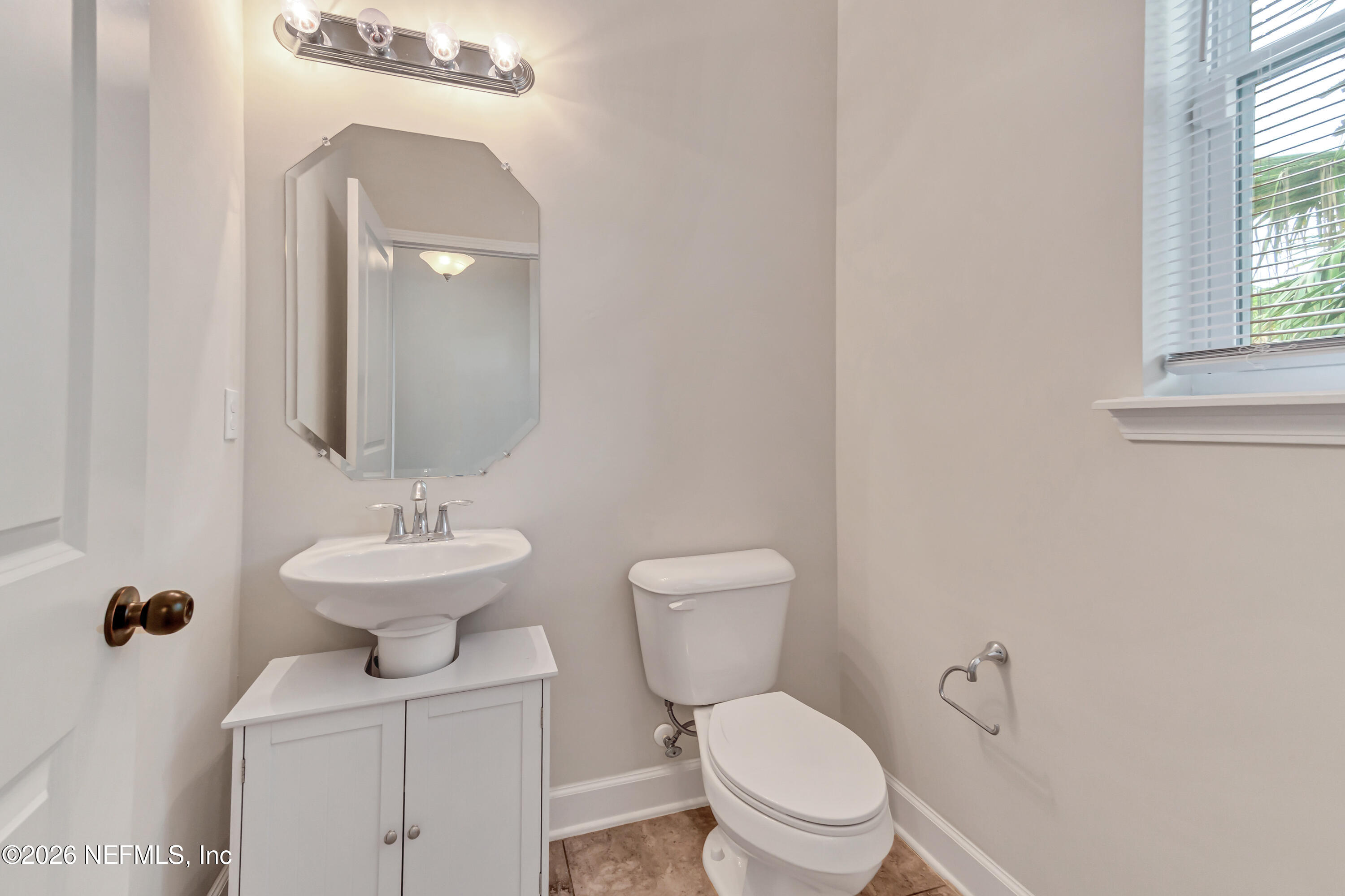 15715 Tisons Bluff Road Jacksonville, FL 32218 - Photo 9 of 48 a bathroom with a toilet sink and mirror