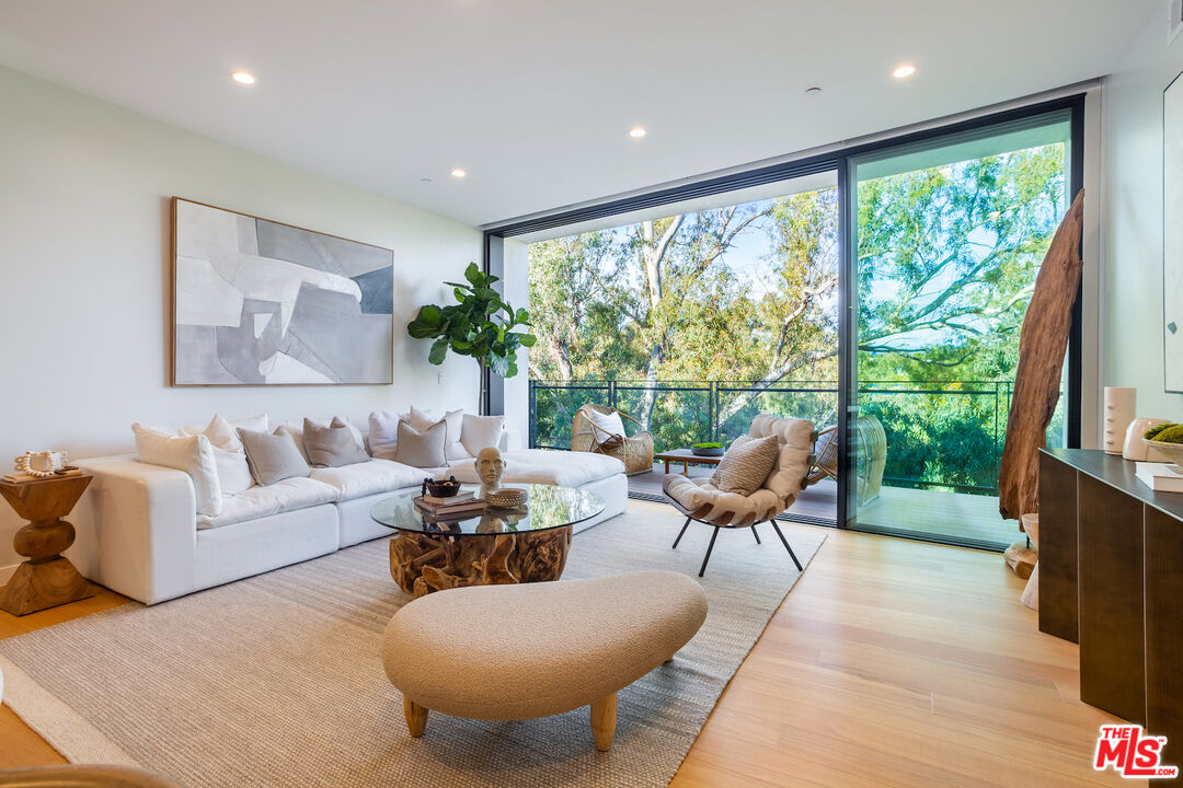 11600 Dunstan Way, Unit 214 Los Angeles, CA 90049 - Photo 2 of 12 a living room with furniture and a large window