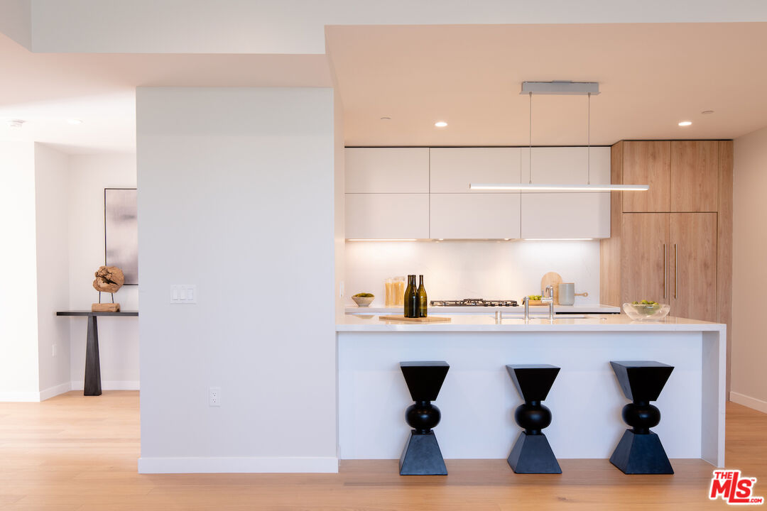 11600 Dunstan Way, Unit 214 Los Angeles, CA 90049 - Photo 3 of 12 a kitchen with stainless steel appliances granite countertop a sink and a refrigerator